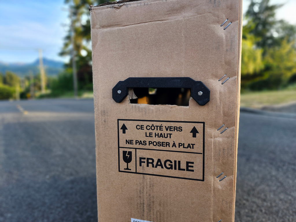 Roll Pack turns any cardboard box into a smooth rolling travel case.